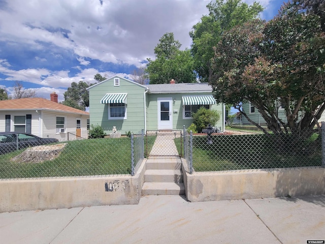1031 Mckinley Ave, Rock Springs, WY 82901 - bungalow-style home featuring a fenced front yard and a gate