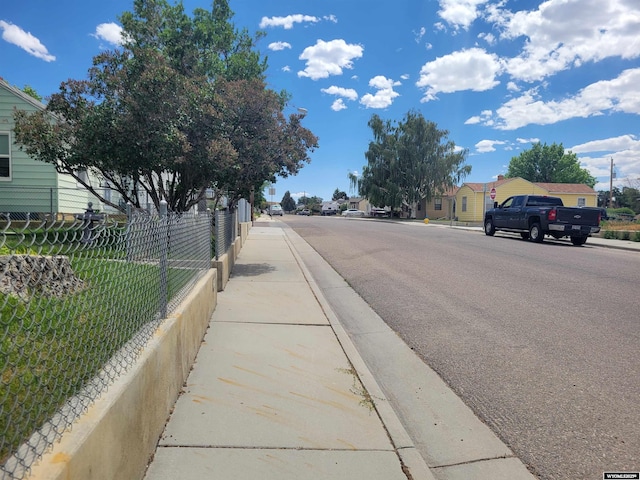 1031 Mckinley Ave, Rock Springs, WY 82901 - view of asphalt road featuring sidewalks, curbs, and a residential view