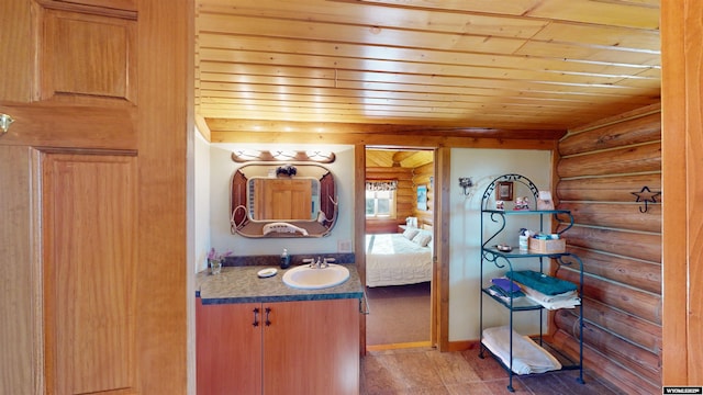 11 Heather Ln, Lander, WY 82520 - bathroom with rustic walls, wooden ceiling, vanity, and ensuite bath