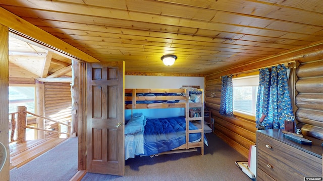 11 Heather Ln, Lander, WY 82520 - carpeted bedroom featuring log walls and wooden ceiling