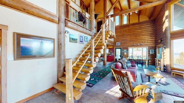 11 Heather Ln, Lander, WY 82520 - living area with high vaulted ceiling, stairs, log walls, and a wooden ceiling with exposed beams