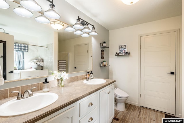 750 N Adams Ave, Buffalo, WY 82834 - bathroom with a shower, double vanity, and wood finished floors