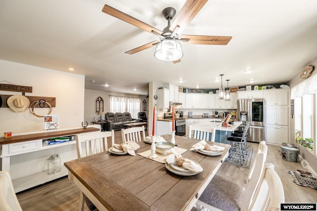 750 N Adams Ave, Buffalo, WY 82834 - dining space featuring light wood finished floors, ceiling fan, and recessed lighting