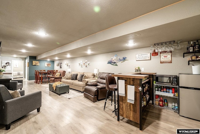 750 N Adams Ave, Buffalo, WY 82834 - living area with a textured ceiling, wood finished floors, and a bar