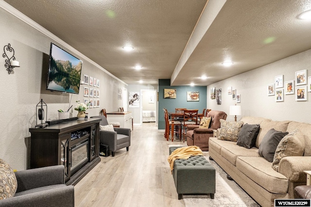 750 N Adams Ave, Buffalo, WY 82834 - living room with light wood-type flooring, a textured ceiling, crown molding, and recessed lighting