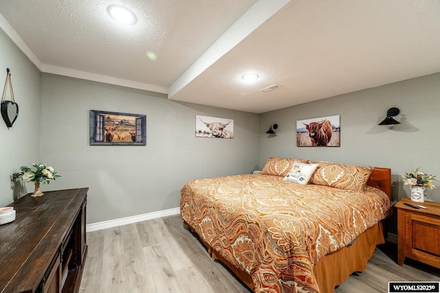 750 N Adams Ave, Buffalo, WY 82834 - bedroom featuring light wood-style flooring, a textured ceiling, and recessed lighting