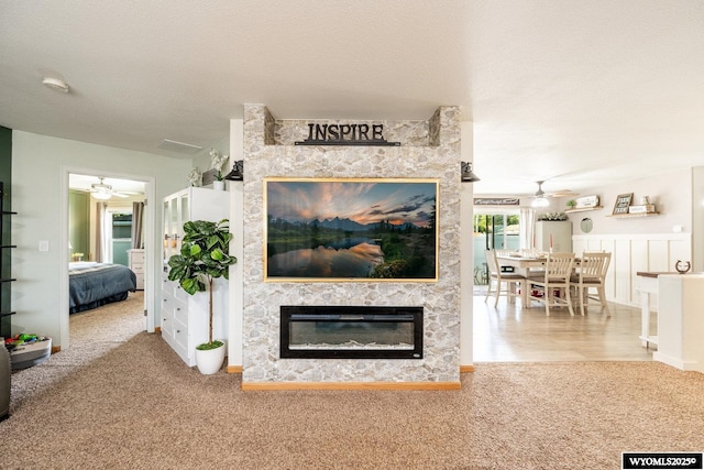 750 N Adams Ave, Buffalo, WY 82834 - living area with a ceiling fan, carpet, and a glass covered fireplace