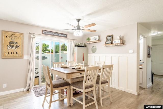 750 N Adams Ave, Buffalo, WY 82834 - dining space with a ceiling fan, light wood-type flooring, and a wainscoted wall