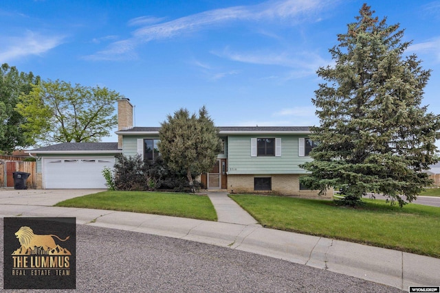 3710 Arroyo Dr, Casper, WY 82604 - view of front of property featuring concrete driveway, a garage, a chimney, and brick siding