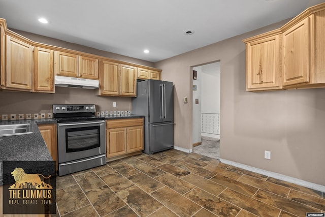 3710 Arroyo Dr, Casper, WY 82604 - kitchen featuring stainless steel appliances, under cabinet range hood, dark countertops, light brown cabinetry, and recessed lighting