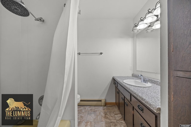 3710 Arroyo Dr, Casper, WY 82604 - full bath featuring a baseboard radiator, vanity, and stone finish floors