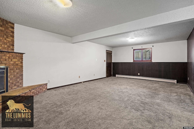 3710 Arroyo Dr, Casper, WY 82604 - unfurnished living room with a baseboard radiator, carpet, a textured ceiling, wainscoting, and a fireplace
