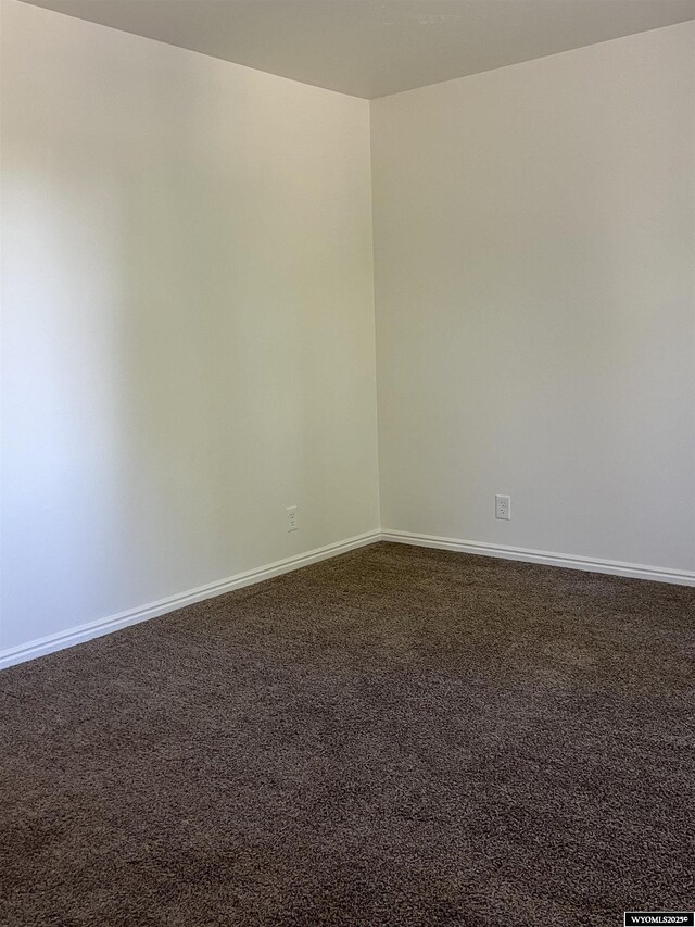 721 Sioux, Evanston, WY 82930 - empty room with dark colored carpet and baseboards