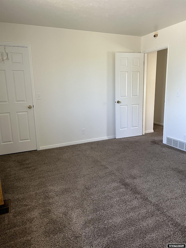 721 Sioux, Evanston, WY 82930 - spare room with dark colored carpet and baseboards