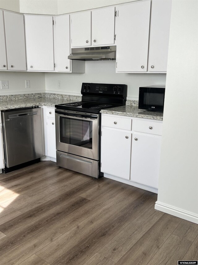 721 Sioux, Evanston, WY 82930 - kitchen featuring appliances with stainless steel finishes, under cabinet range hood, white cabinets, and dark wood-style flooring