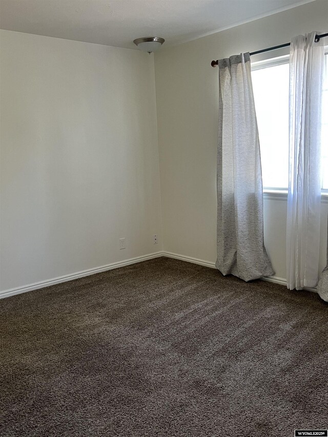 721 Sioux, Evanston, WY 82930 - unfurnished room with dark colored carpet and baseboards