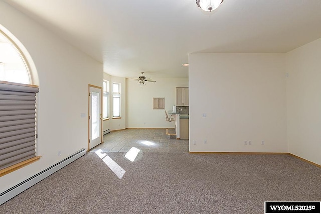 2215 Silver Creek Dr, Rock Springs, WY 82901 - unfurnished living room with baseboard heating, light colored carpet, and a ceiling fan