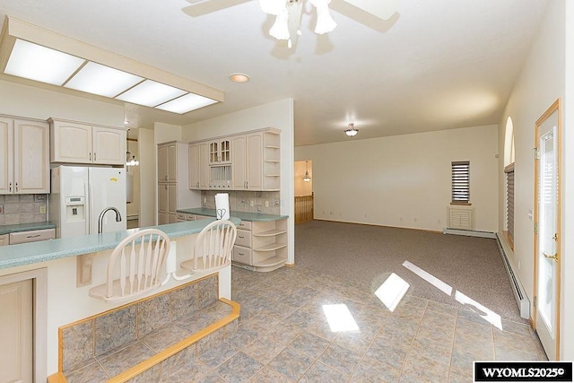 2215 Silver Creek Dr, Rock Springs, WY 82901 - kitchen featuring white refrigerator with ice dispenser, open shelves, ceiling fan, backsplash, and cream cabinetry