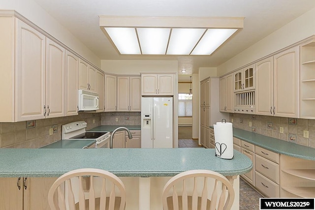 2215 Silver Creek Dr, Rock Springs, WY 82901 - kitchen featuring white appliances, open shelves, a peninsula, and tasteful backsplash