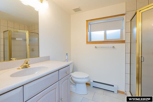 2215 Silver Creek Dr, Rock Springs, WY 82901 - bathroom featuring baseboard heating, tile patterned flooring, vanity, and a stall shower