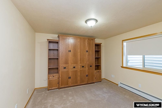 2215 Silver Creek Dr, Rock Springs, WY 82901 - unfurnished bedroom featuring a baseboard heating unit and light carpet