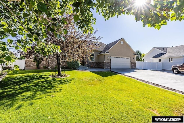 2215 Silver Creek Dr, Rock Springs, WY 82901 - view of front facade featuring driveway, stucco siding, a garage, and stone siding