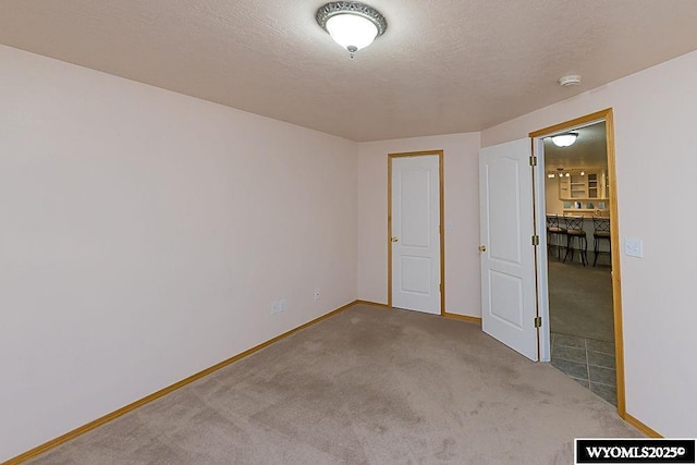 2215 Silver Creek Dr, Rock Springs, WY 82901 - carpeted empty room featuring a smoke detector and a textured ceiling