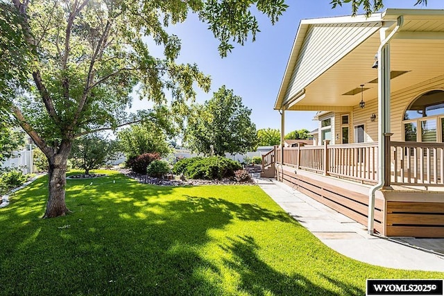 2215 Silver Creek Dr, Rock Springs, WY 82901 - view of green lawn featuring a porch