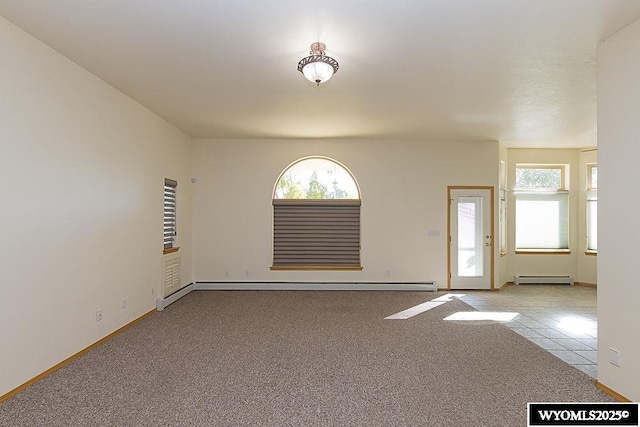 2215 Silver Creek Dr, Rock Springs, WY 82901 - empty room featuring a baseboard radiator, carpet flooring, and tile patterned flooring