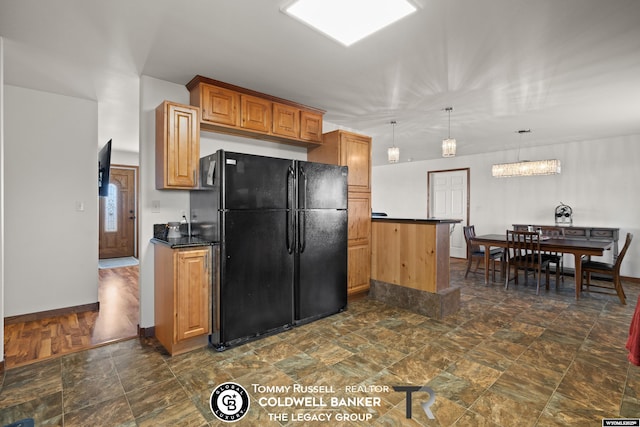 1728 James, Casper, WY 82601 - kitchen featuring freestanding refrigerator, dark countertops, dark stone finish flooring, and pendant lighting