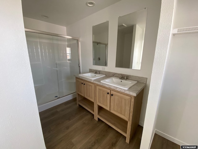 601 24th St Lot N31, Rawlins, WY 82301 - full bathroom featuring wood finished floors, a shower stall, and double vanity