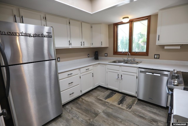 609 Klondike Dr, Buffalo, WY 82834 - kitchen featuring appliances with stainless steel finishes, white cabinetry, light countertops, and dark wood finished floors