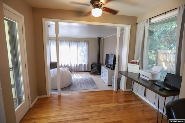609 Klondike Dr, Buffalo, WY 82834 - living room featuring a ceiling fan, light wood-style flooring, and a wood stove