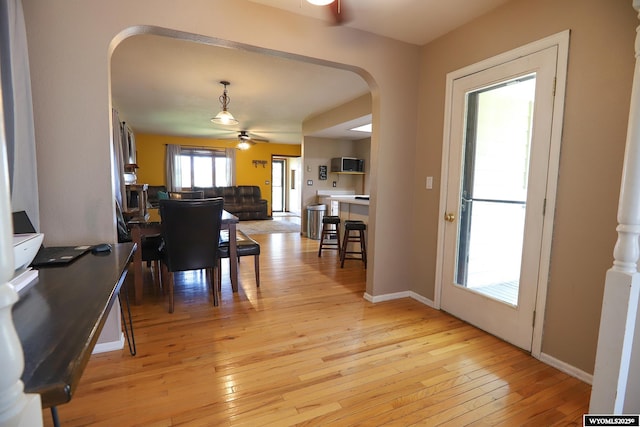 609 Klondike Dr, Buffalo, WY 82834 - dining space featuring arched walkways, light wood-style flooring, and ceiling fan