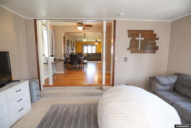 609 Klondike Dr, Buffalo, WY 82834 - living room with ceiling fan, light wood finished floors, ornamental molding, and arched walkways