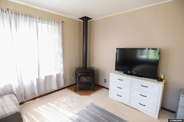 609 Klondike Dr, Buffalo, WY 82834 - living area featuring a wood stove, light colored carpet, and ornamental molding