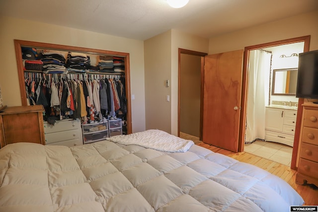 609 Klondike Dr, Buffalo, WY 82834 - bedroom featuring a closet, light wood-type flooring, and ensuite bathroom
