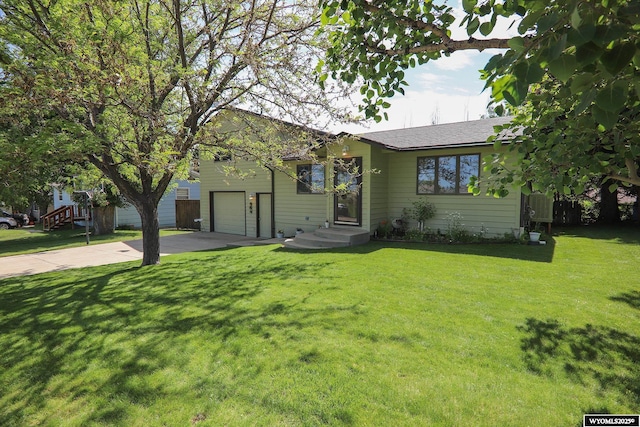 609 Klondike Dr, Buffalo, WY 82834 - ranch-style house featuring driveway, a garage, a front yard, and a shingled roof