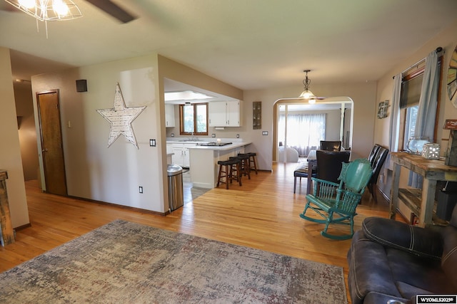 609 Klondike Dr, Buffalo, WY 82834 - living room with ceiling fan, light wood-style floors, and arched walkways