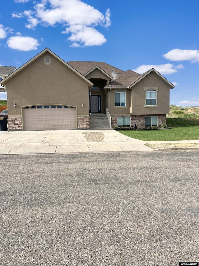 155 Highridge Pt, Evanston, WY 82930 - view of front facade featuring stucco siding, stone siding, and an attached garage