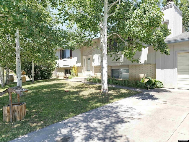 313 Cottonwood St, Evanston, WY 82930 - view of front of property with a front yard and brick siding