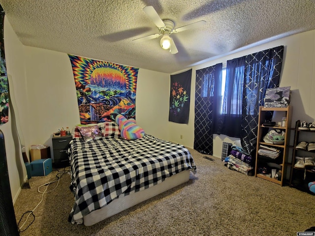 313 Cottonwood St, Evanston, WY 82930 - carpeted bedroom with a textured ceiling and ceiling fan