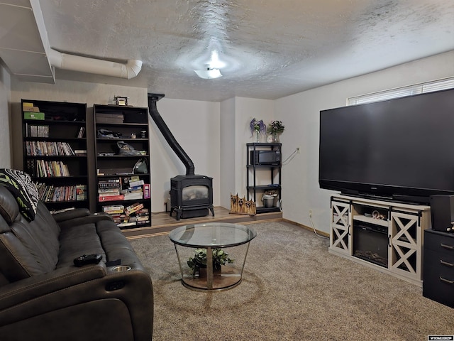 313 Cottonwood St, Evanston, WY 82930 - carpeted living room featuring a wood stove and a textured ceiling
