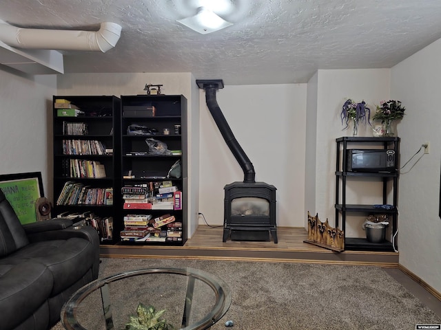 313 Cottonwood St, Evanston, WY 82930 - living area with a wood stove and a textured ceiling