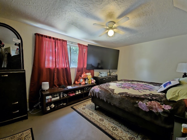 313 Cottonwood St, Evanston, WY 82930 - bedroom with concrete flooring, a textured ceiling, and a ceiling fan