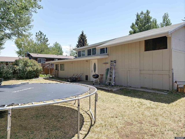 313 Cottonwood St, Evanston, WY 82930 - rear view of house featuring a trampoline