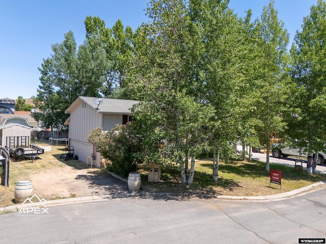 313 Cottonwood St, Evanston, WY 82930 - view of property hidden behind natural elements featuring board and batten siding