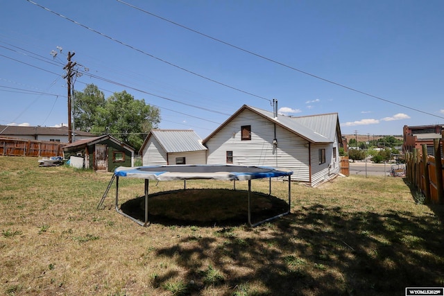1435 Main St, Evanston, WY 82930 - rear view of house featuring a trampoline