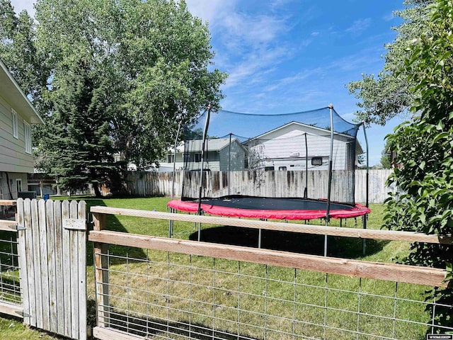 1542 Cloud Peak Dr, Worland, WY 82401 - fenced backyard featuring a trampoline