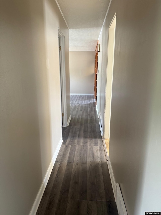 524 E Murray St, Rawlins, WY 82301 - hallway featuring dark wood-style floors and baseboards
